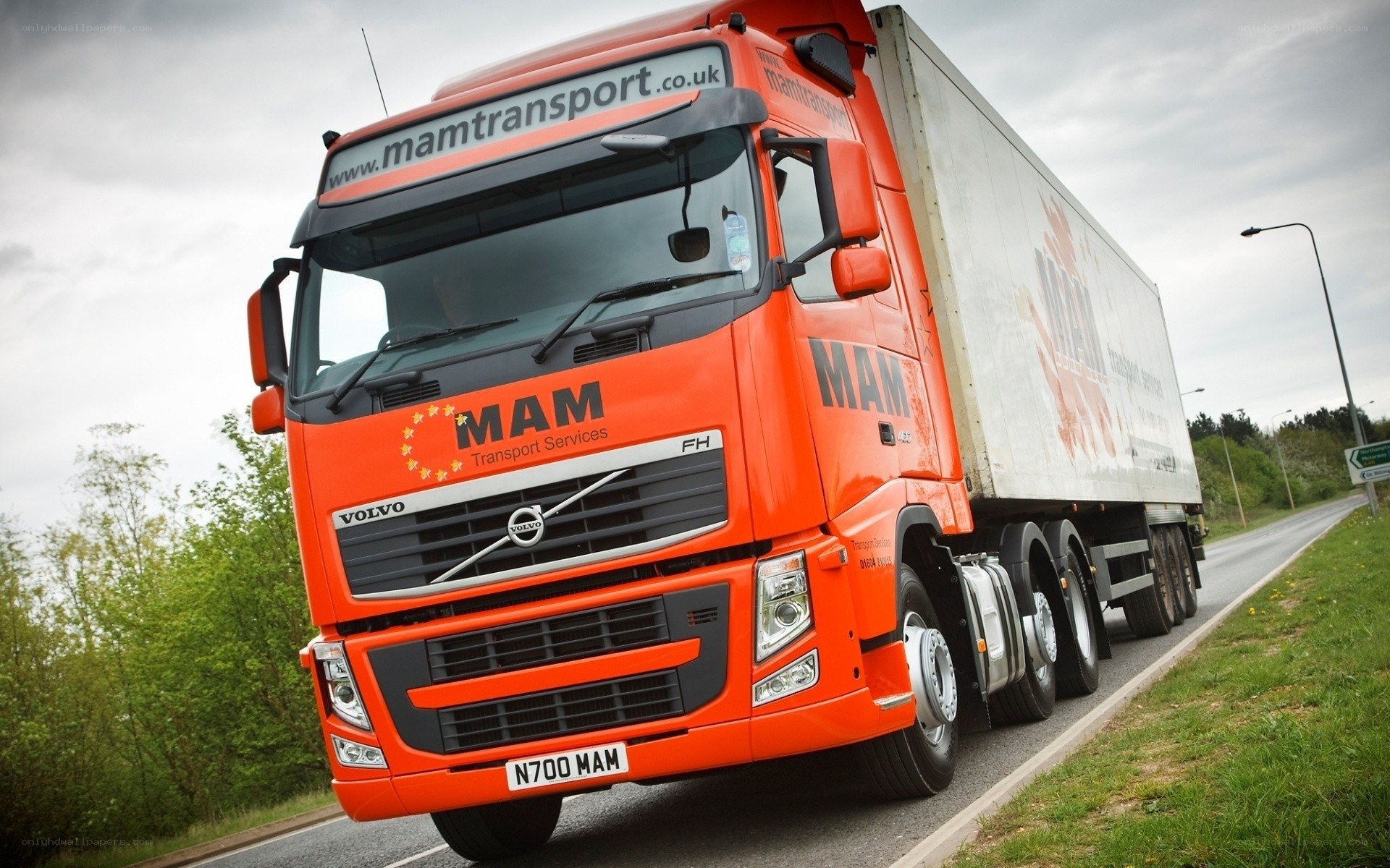 Orange Volvo truck on road