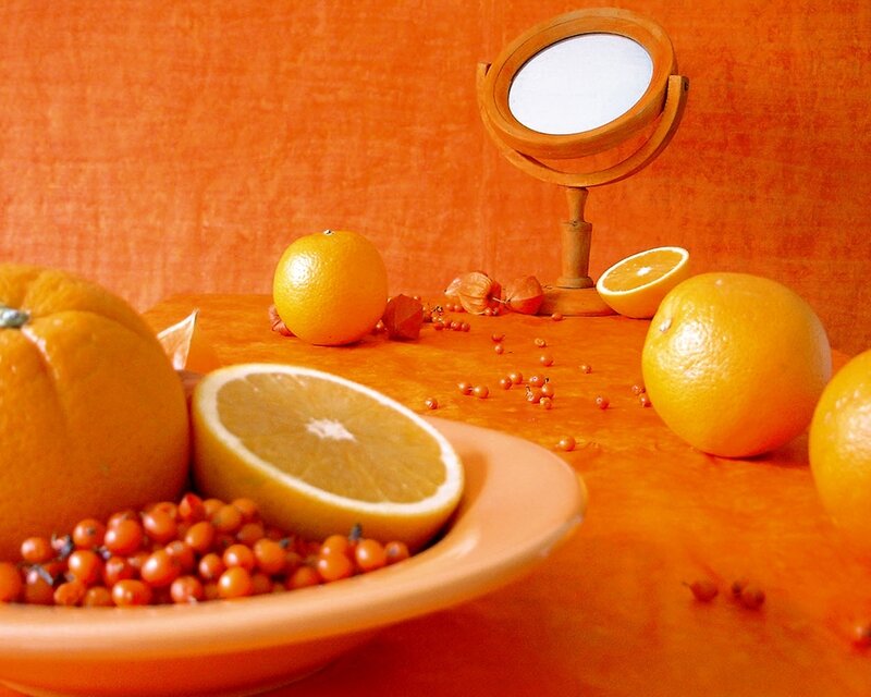 Oranges and berries on orange table
