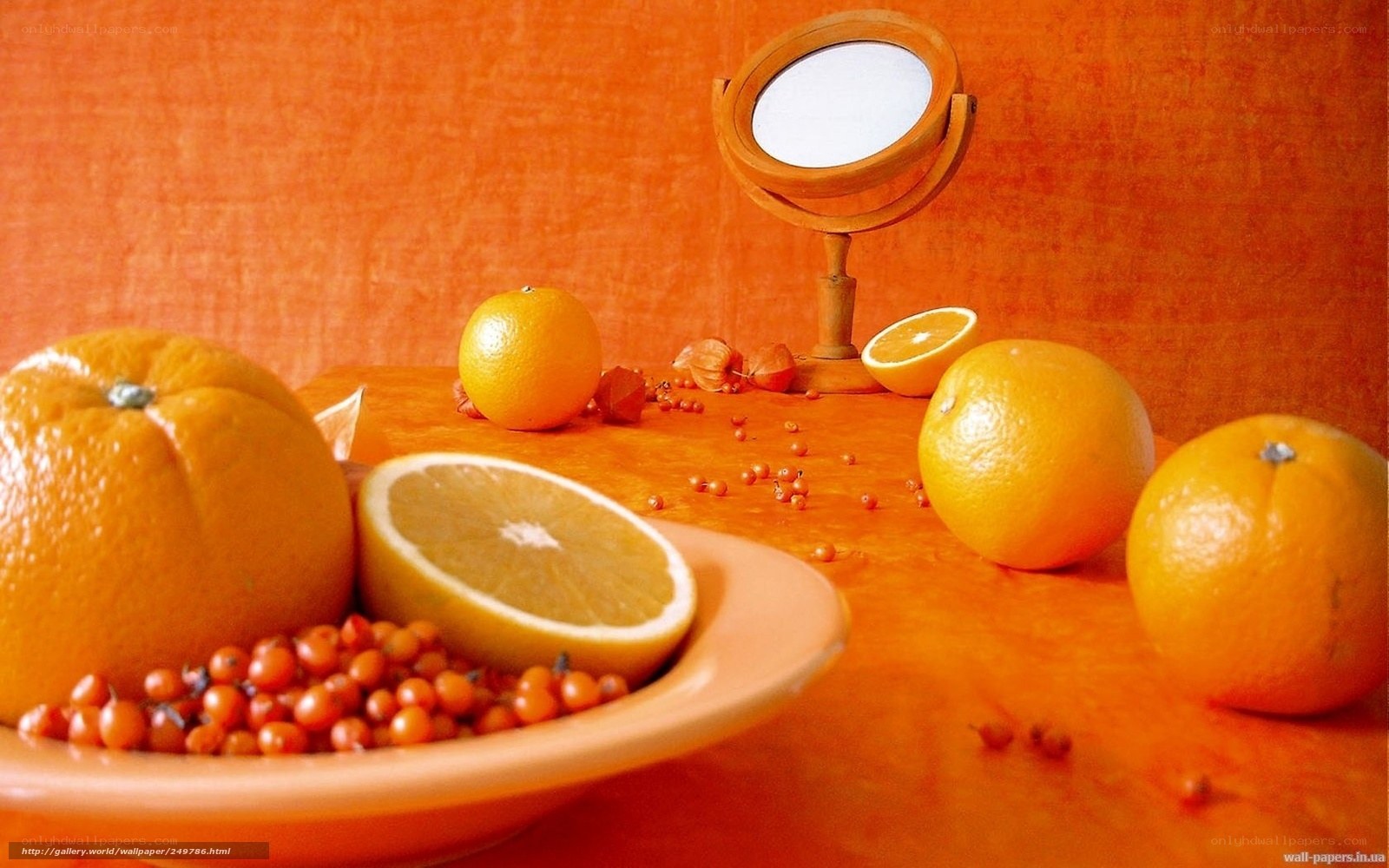 Oranges and berries on orange table