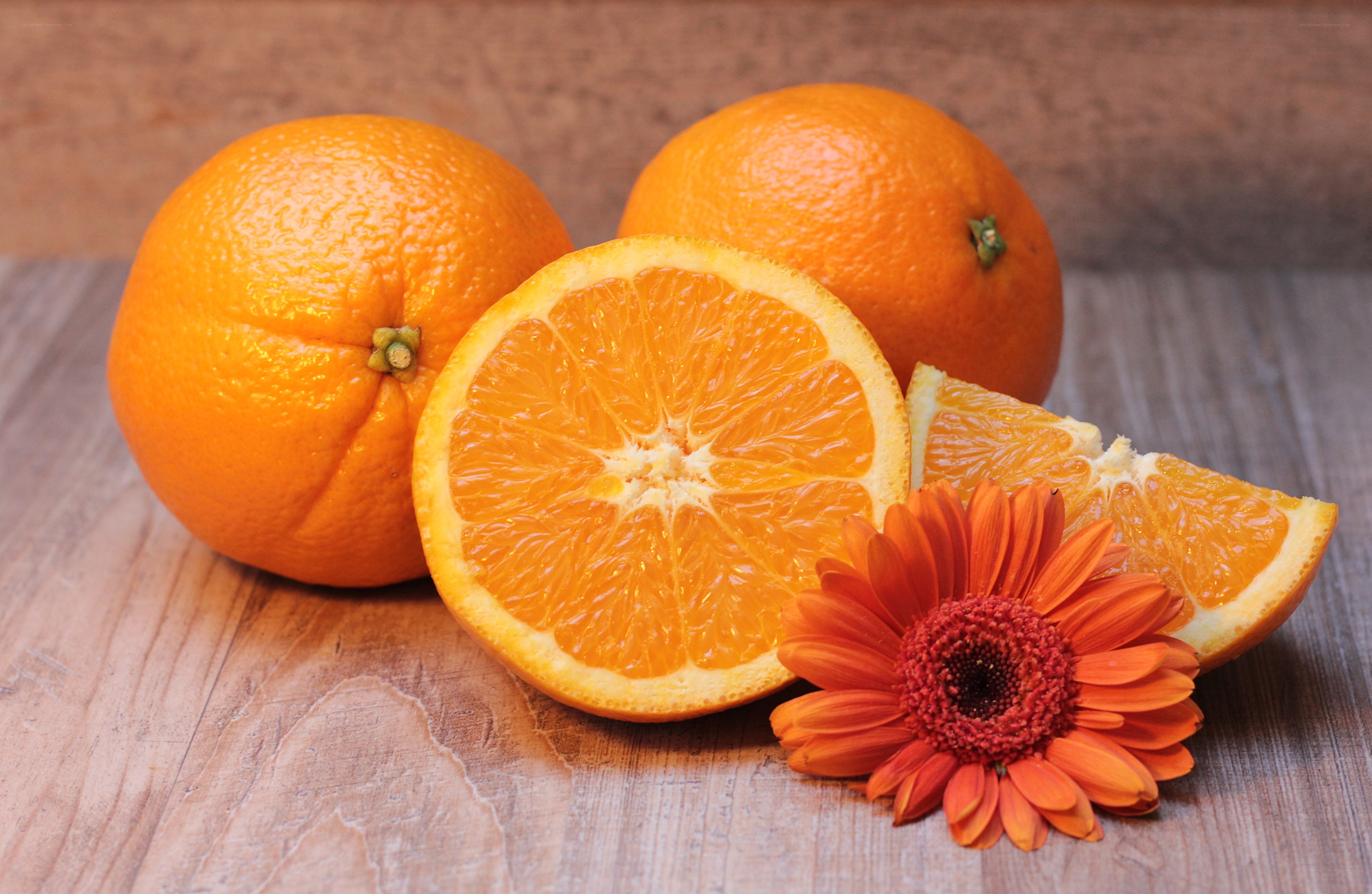 Oranges and flower on wood
