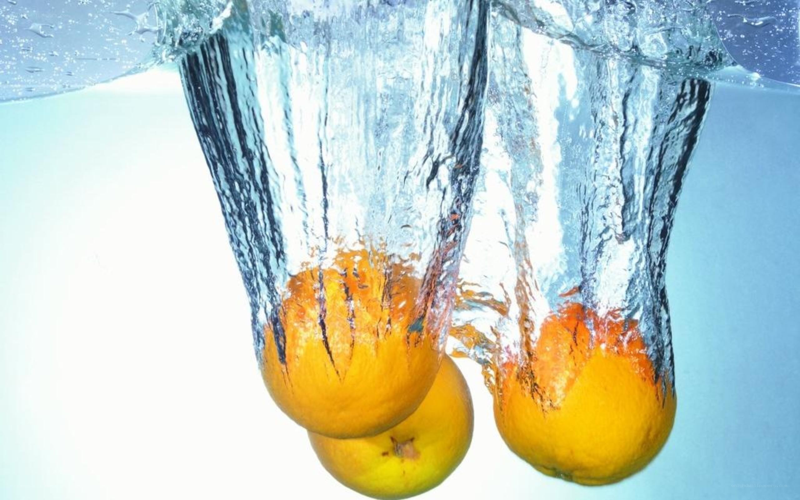 oranges falling into water