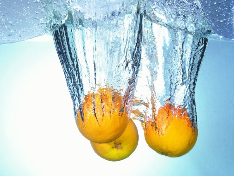 oranges falling into water