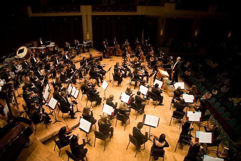 Orchestra Performing on Stage — Black