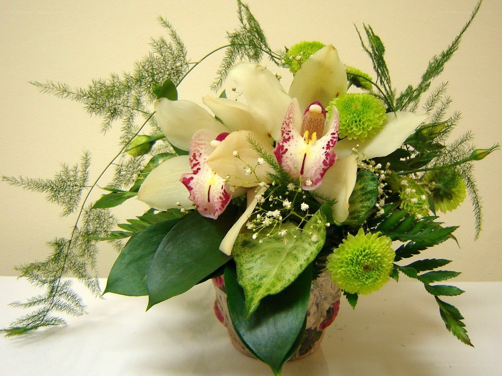 orchid and green flower arrangement