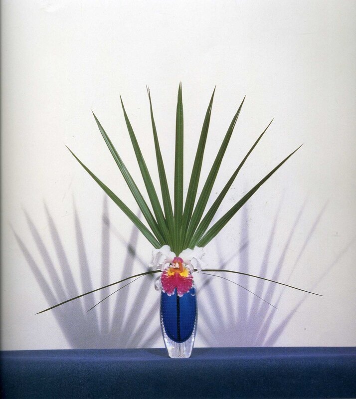 orchid and palm leaf arrangement