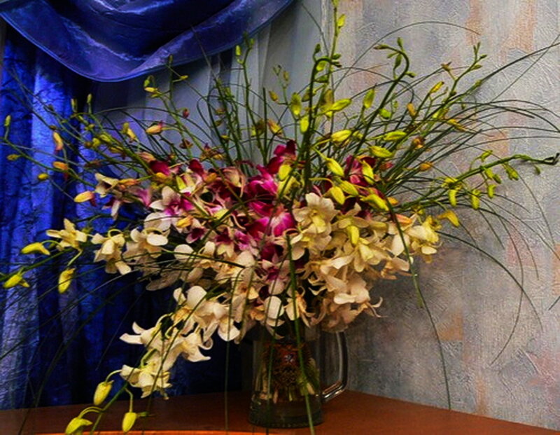 orchid bouquet in a pitcher