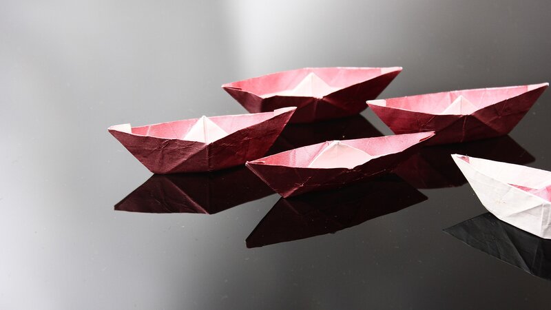 Origami Boats on Surface — Red, Minimalist