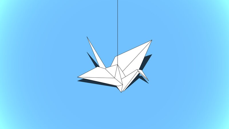 Origami crane hanging in blue sky