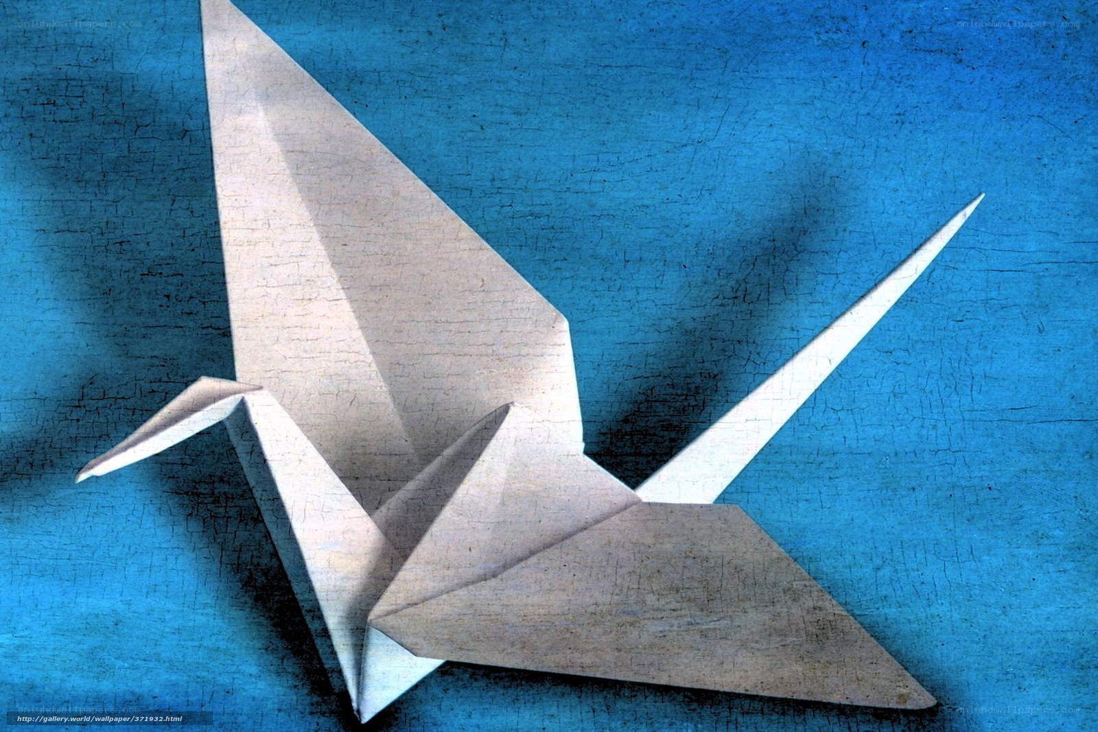 Origami crane on blue background