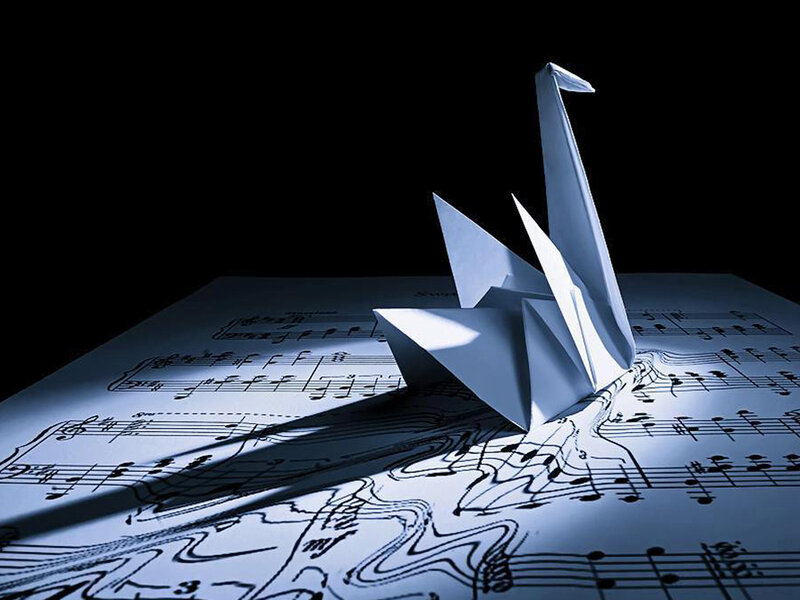 Origami Crane on Sheet Music — White