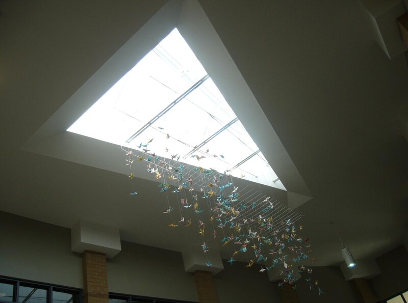 Origami cranes hanging under skylight