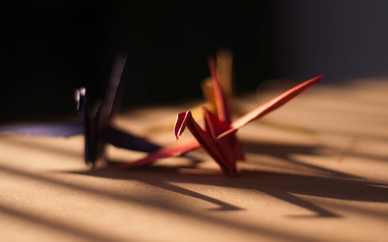 Origami Cranes on Table — Red