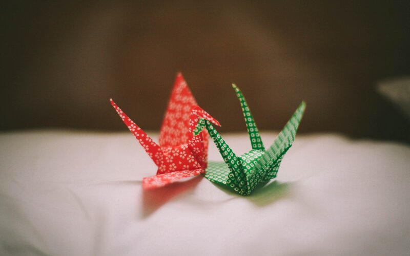 Origami cranes on white surface
