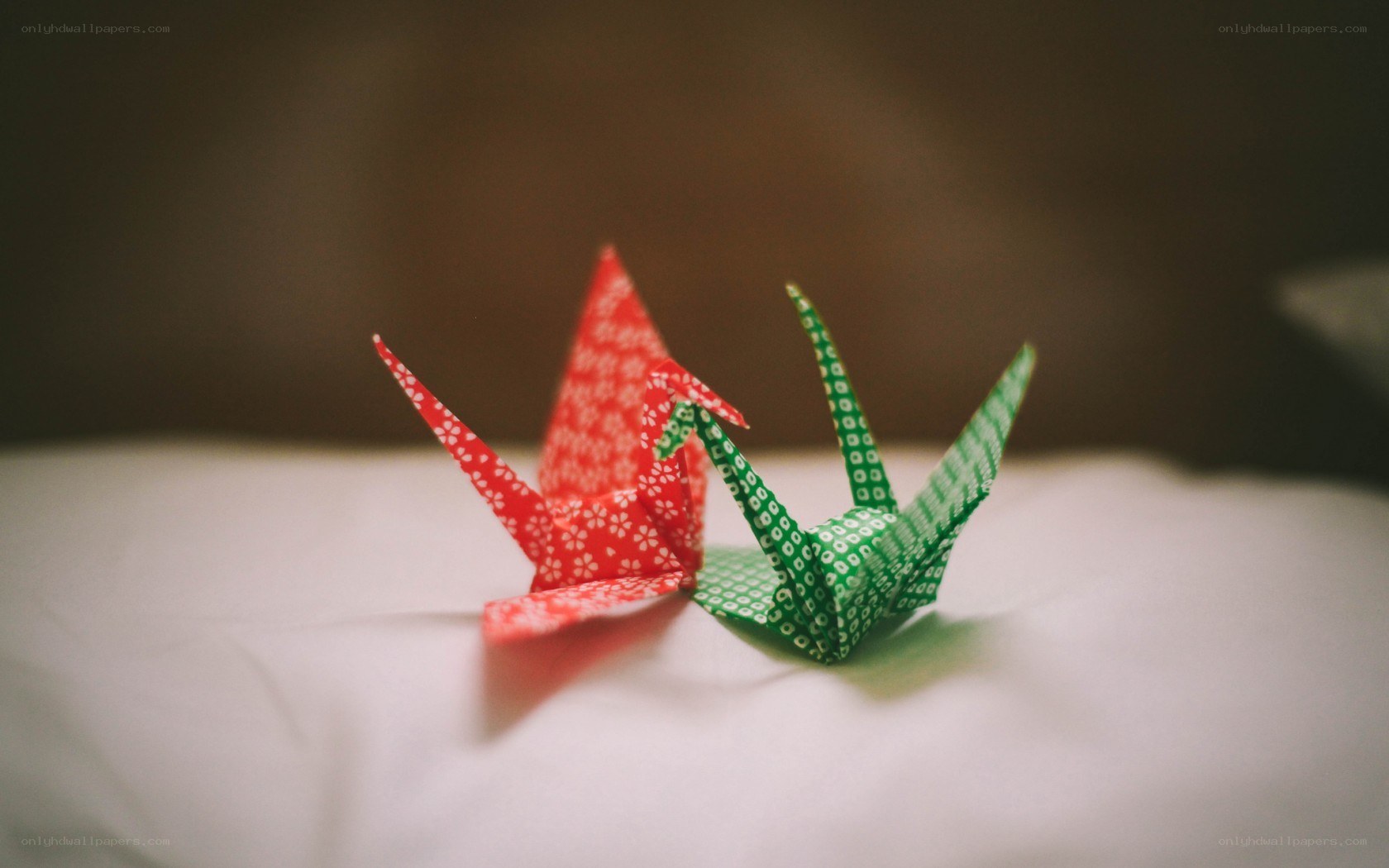 Origami cranes on white surface