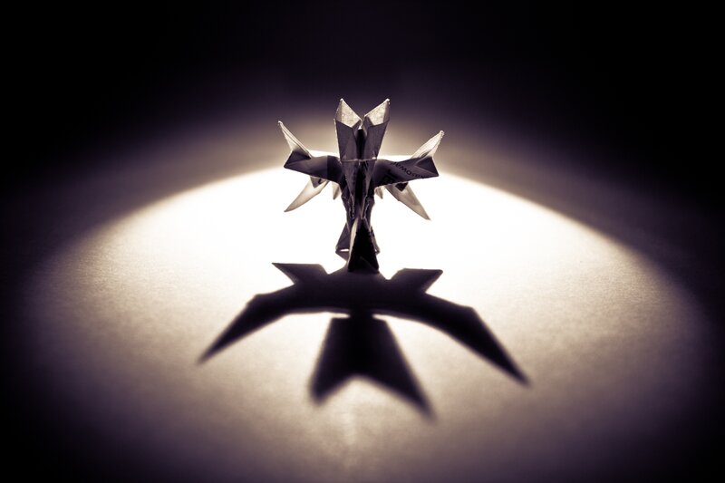 Origami figure in spotlight