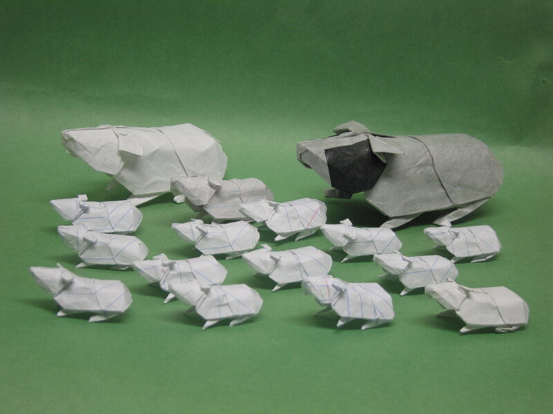 Origami pigs on green
