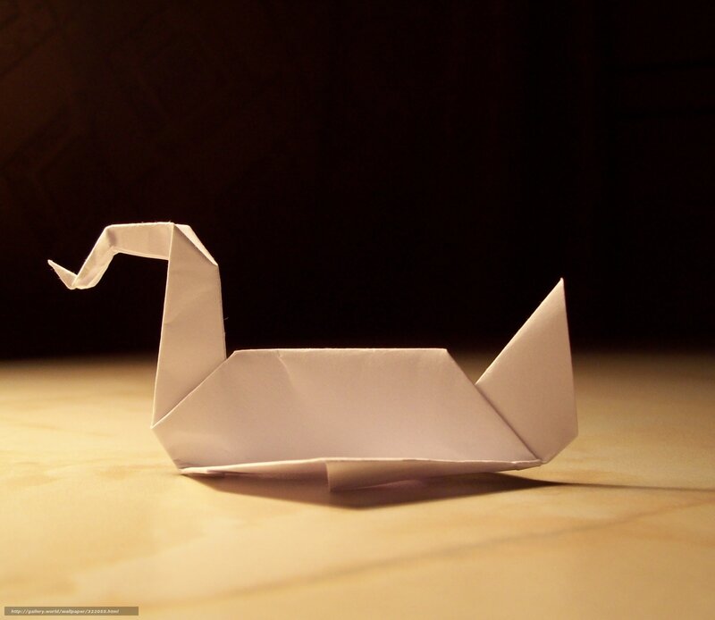 Origami swan on wooden surface