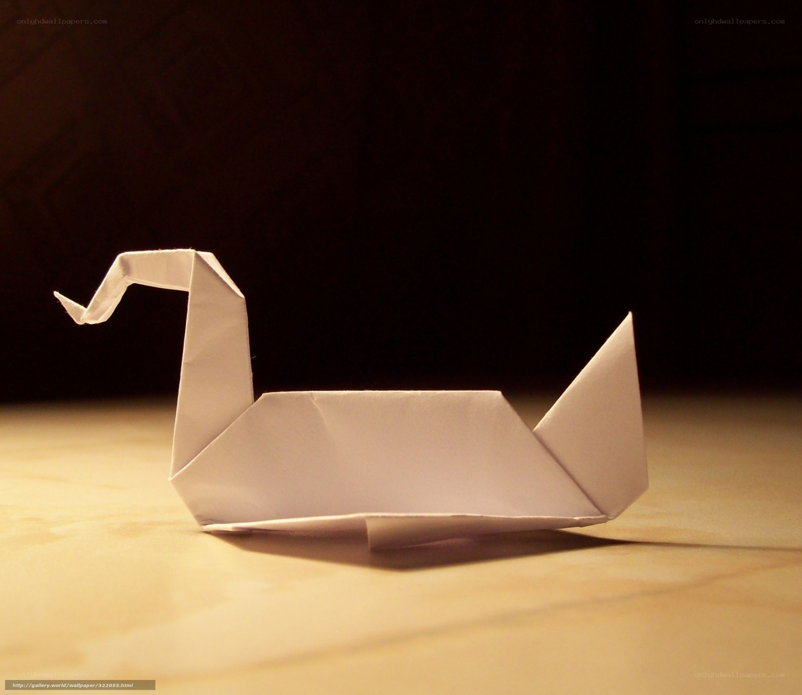 Origami swan on wooden surface