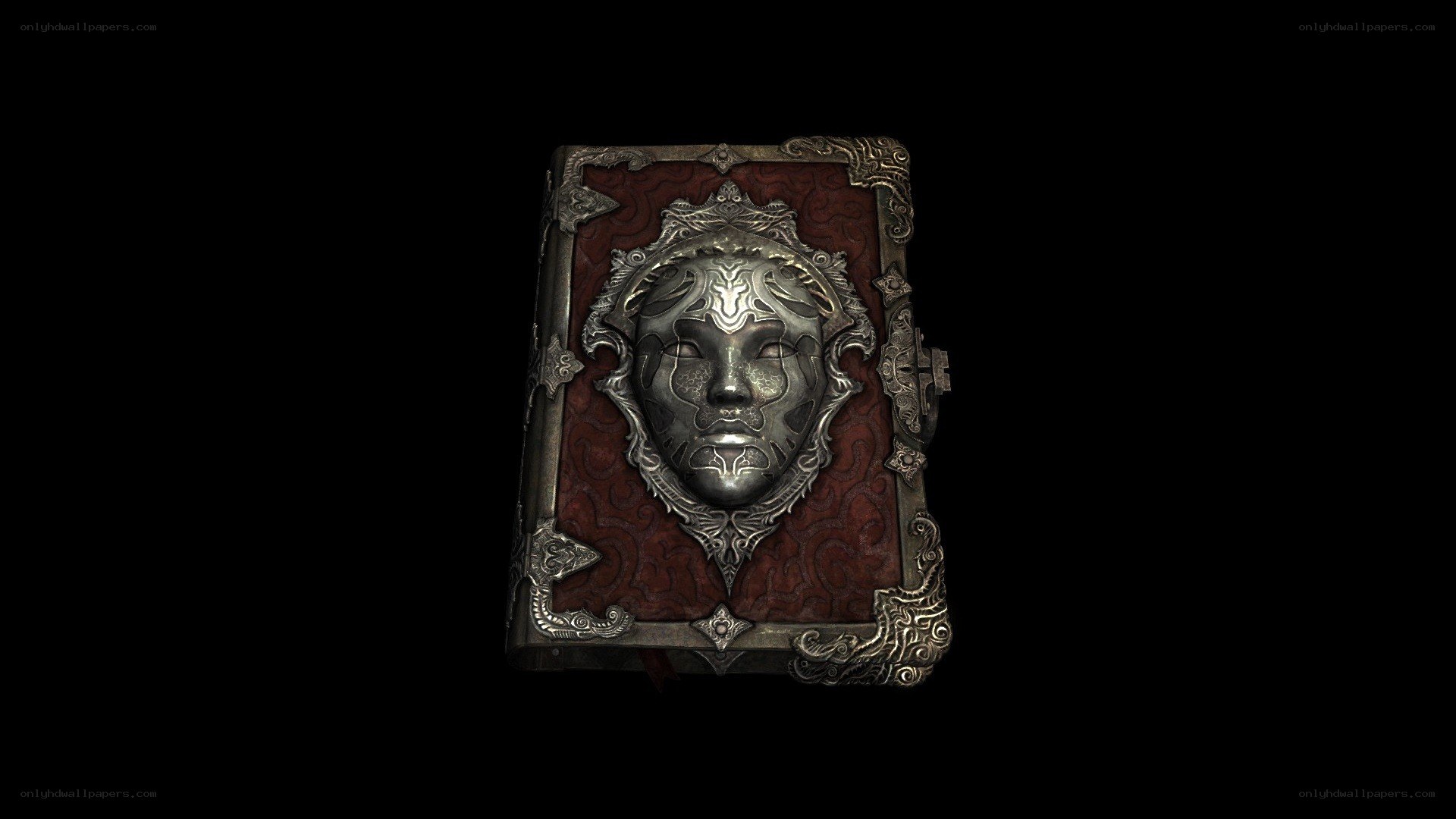 ornate book with mask emblem