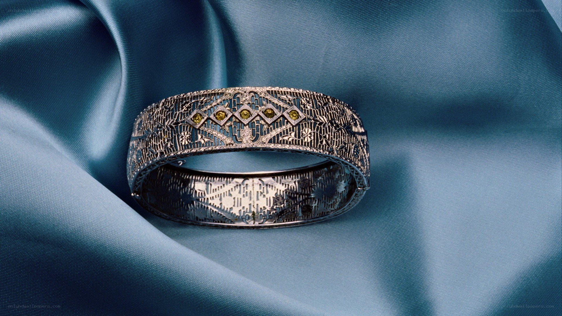 ornate bracelet on blue fabric