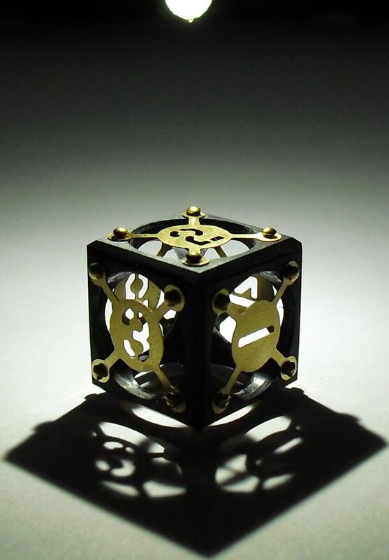 Ornate brass and black cube