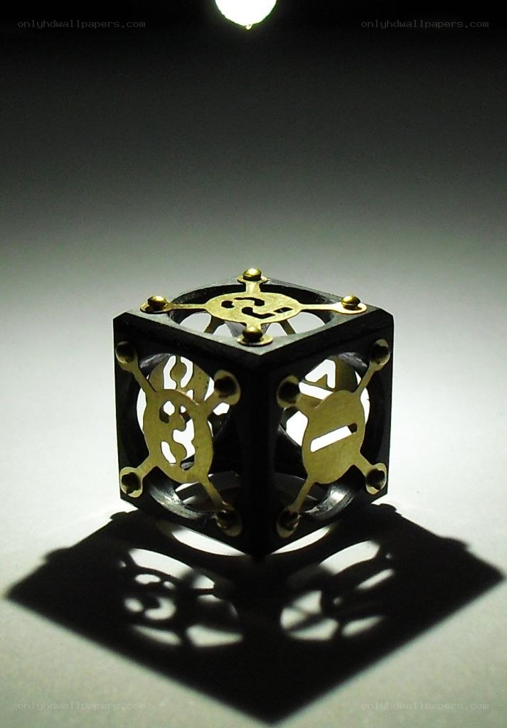 Ornate brass and black cube