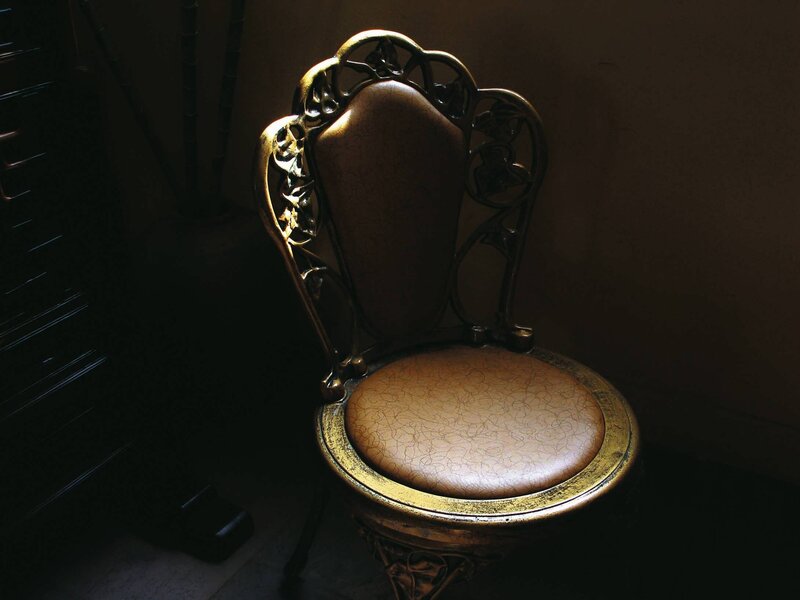 ornate chair in dim light