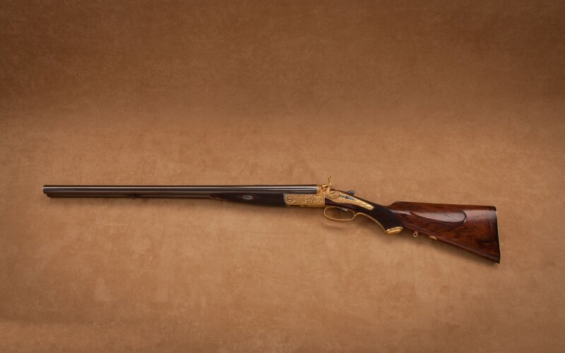 ornate double-barreled shotgun