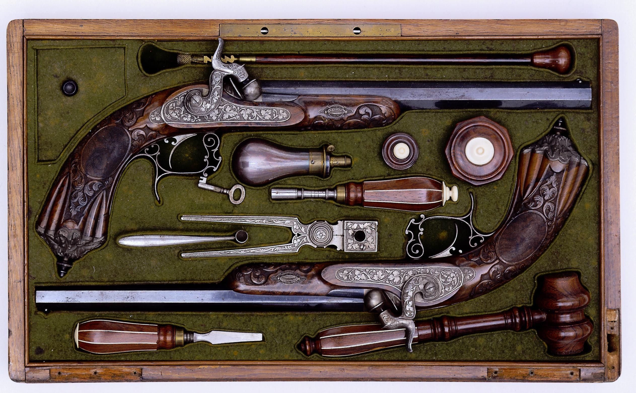 ornate flintlock pistols in case