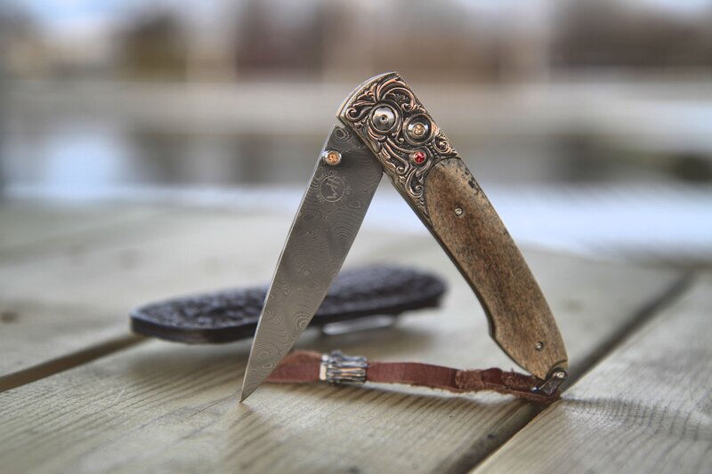 ornate folding knife on wood