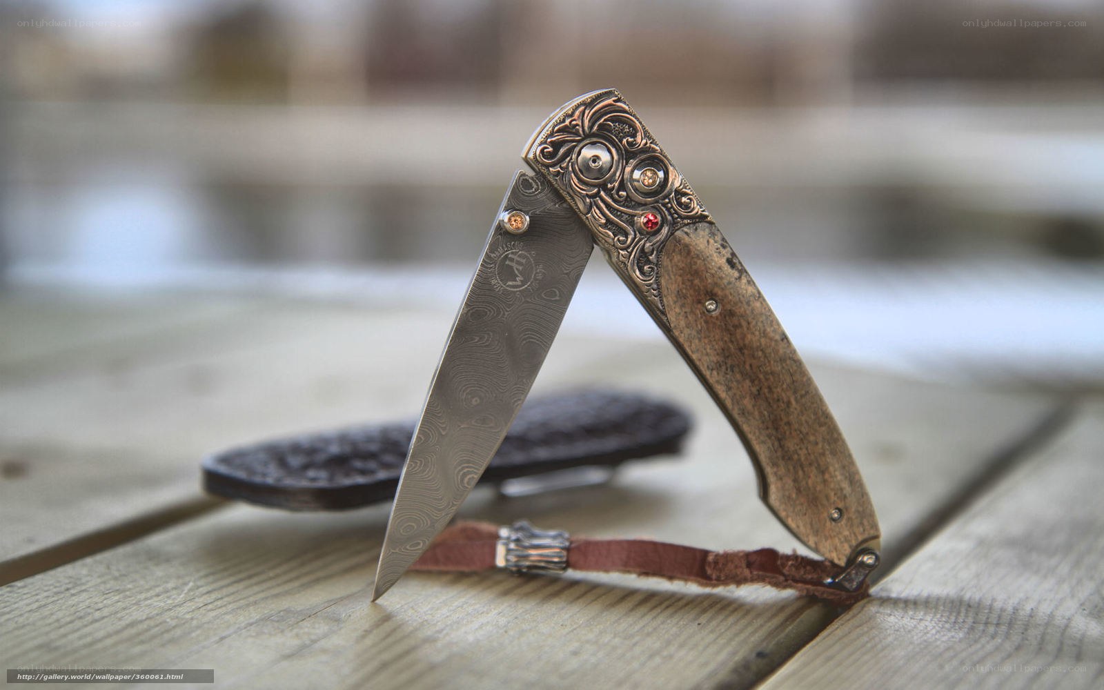 ornate folding knife on wood