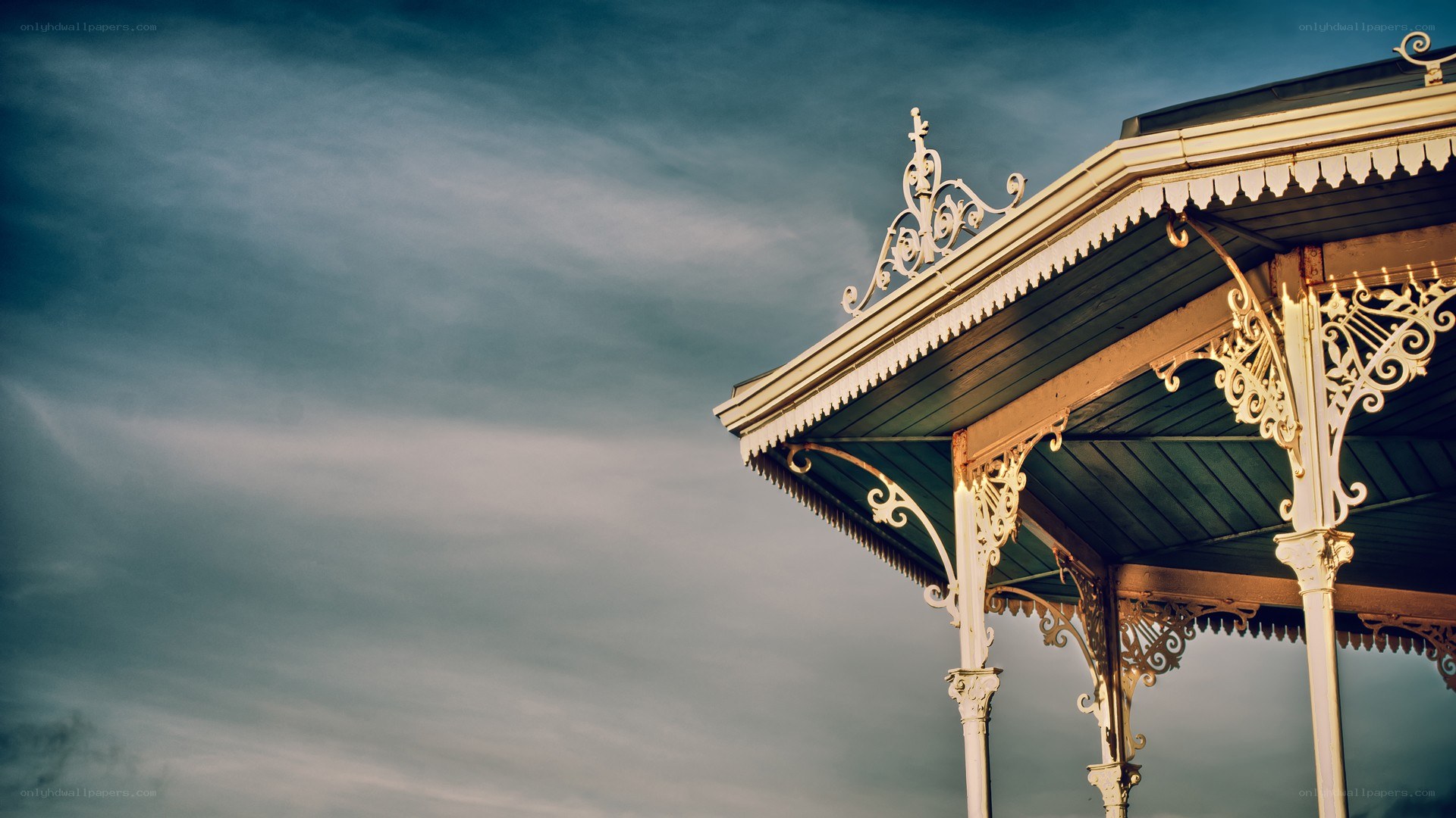 ornate gazebo under cloudy sky