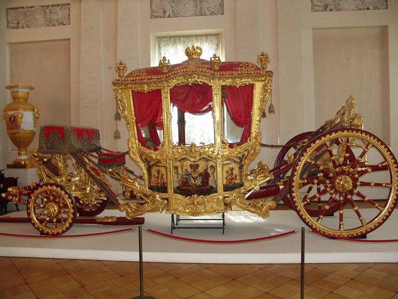 Ornate golden carriage on display