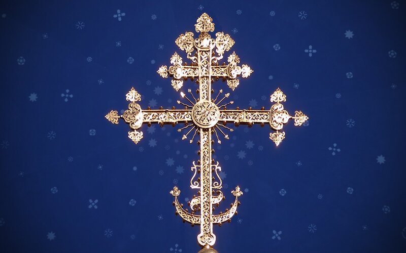 ornate golden cross on blue