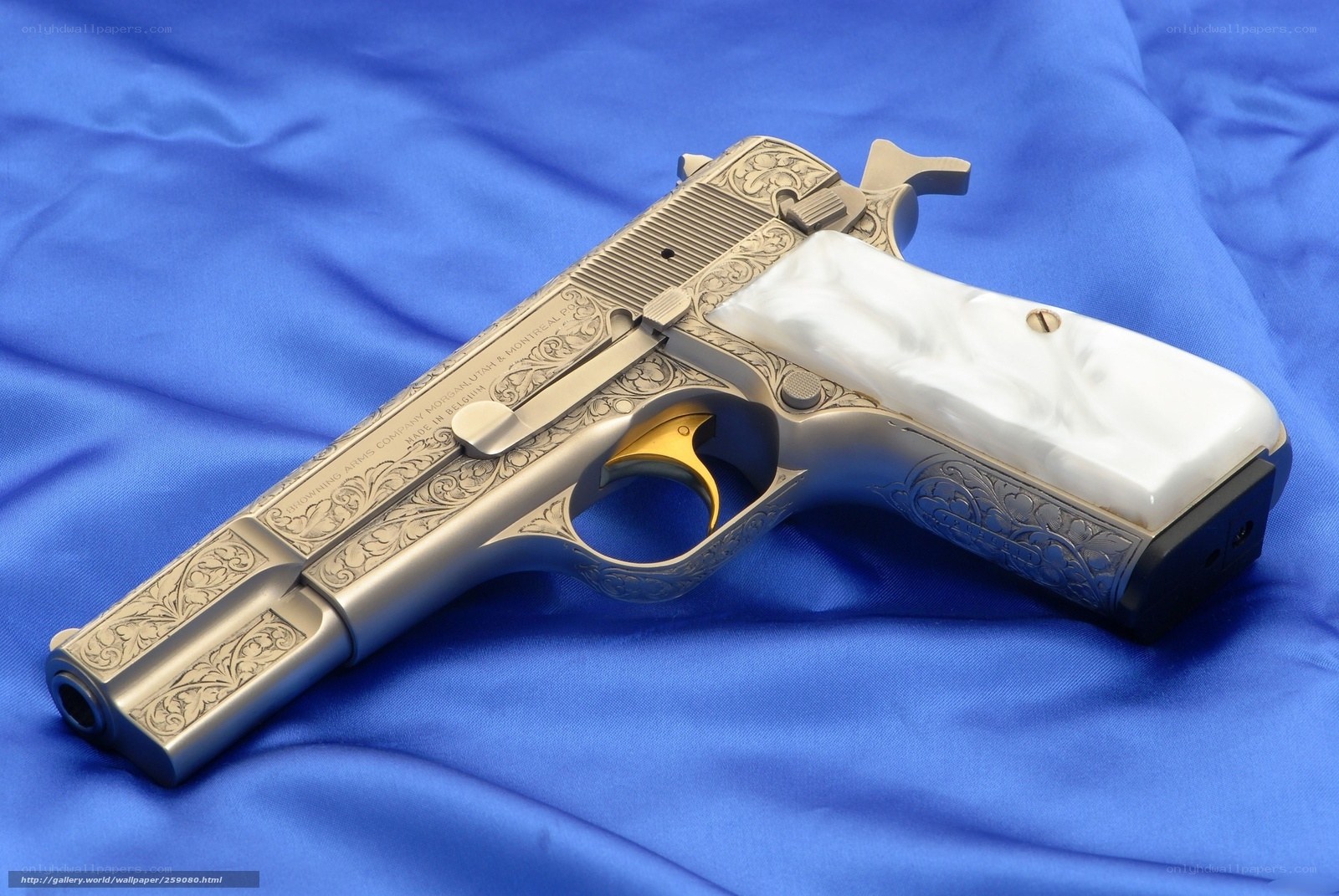 ornate handgun on blue cloth