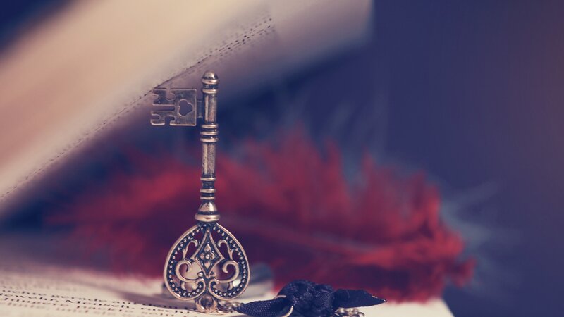 Ornate Key on Book — Silver, Dramatic