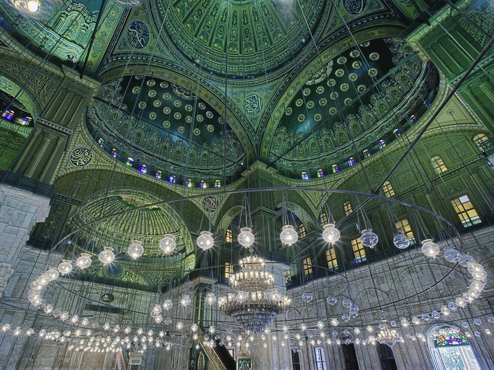 Ornate mosque interior with chandeliers