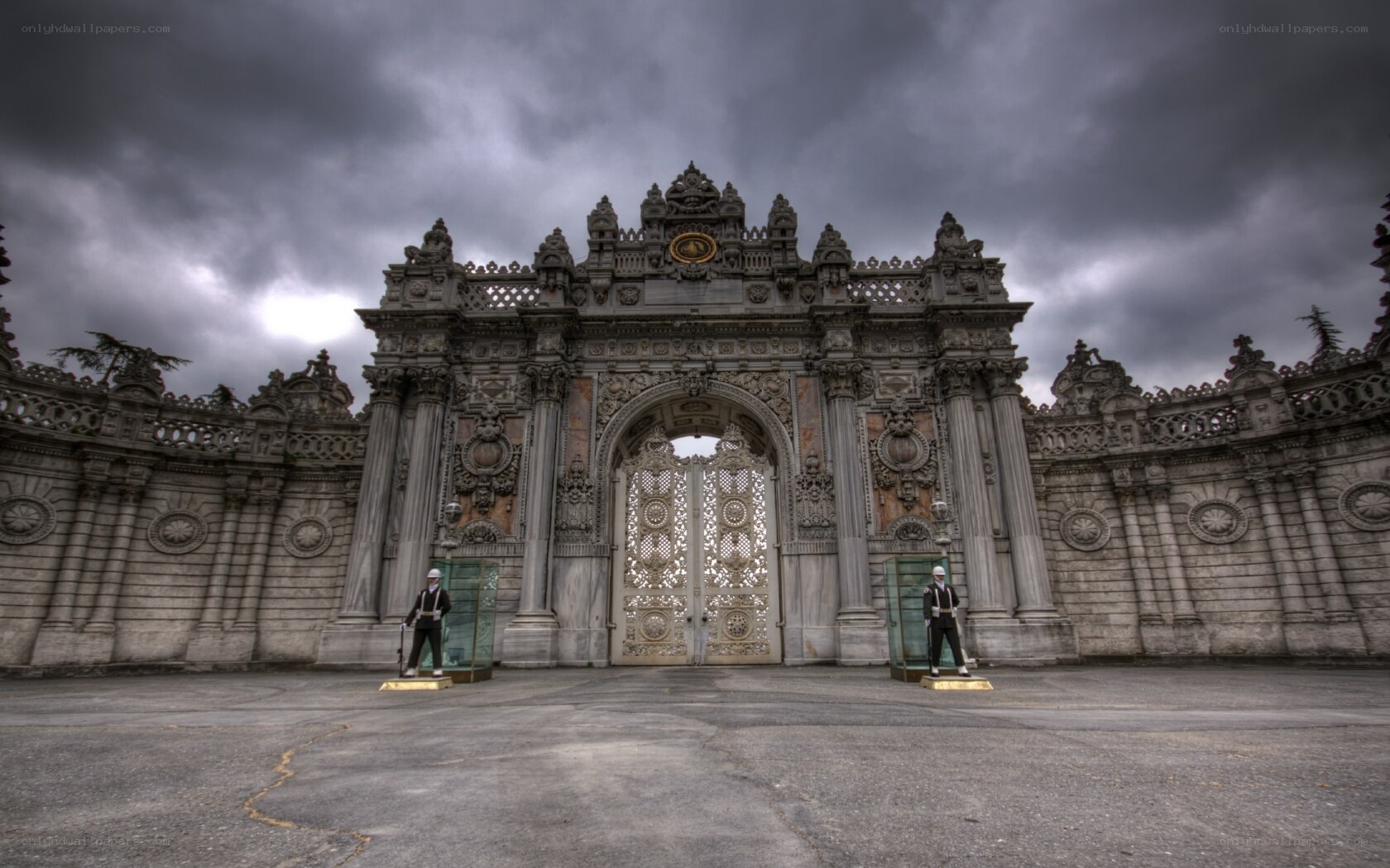 ornate palace gate under stormy sky