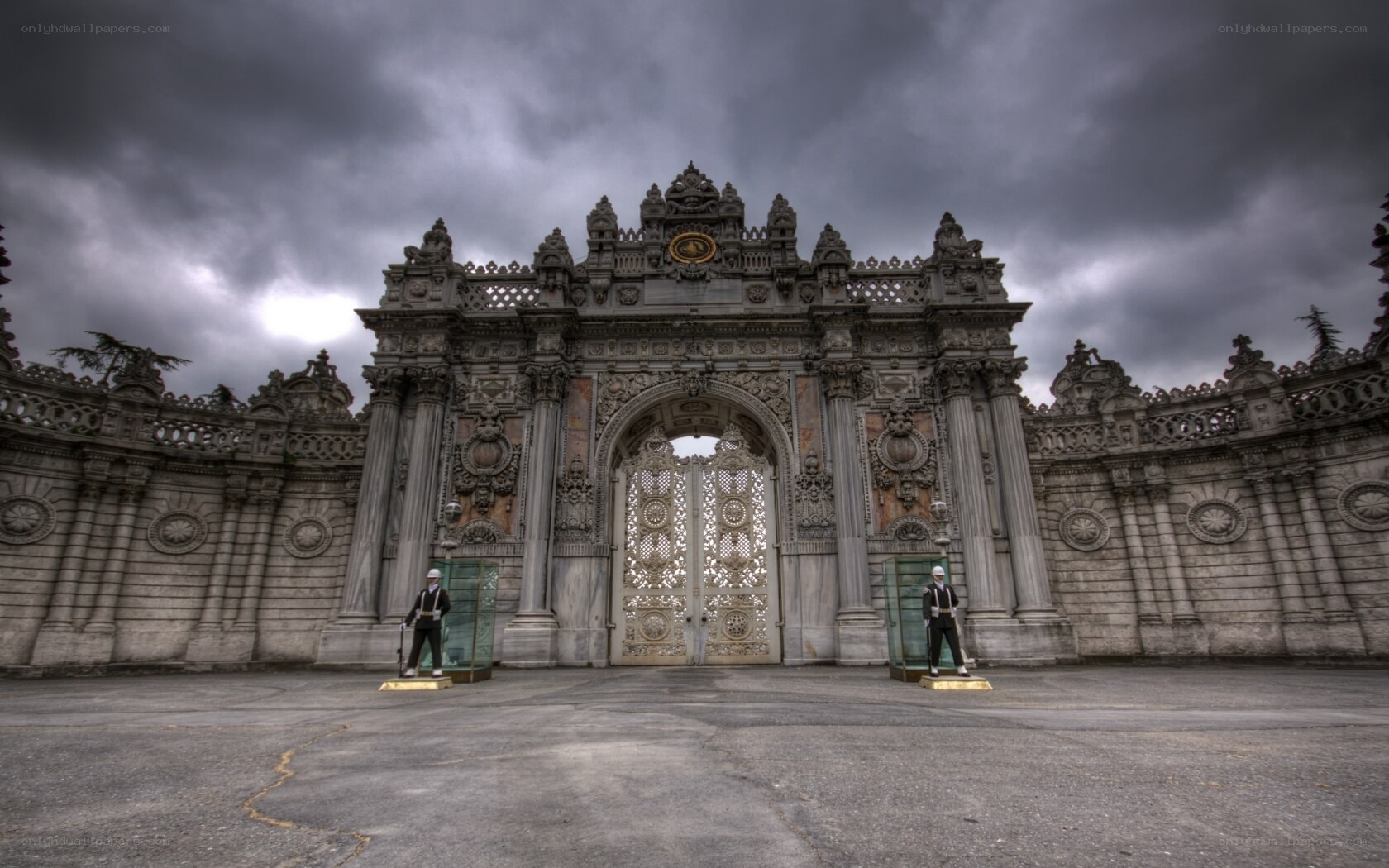 ornate palace gate under stormy sky