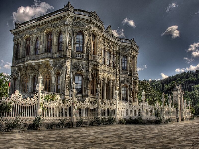 ornate palace with white fence