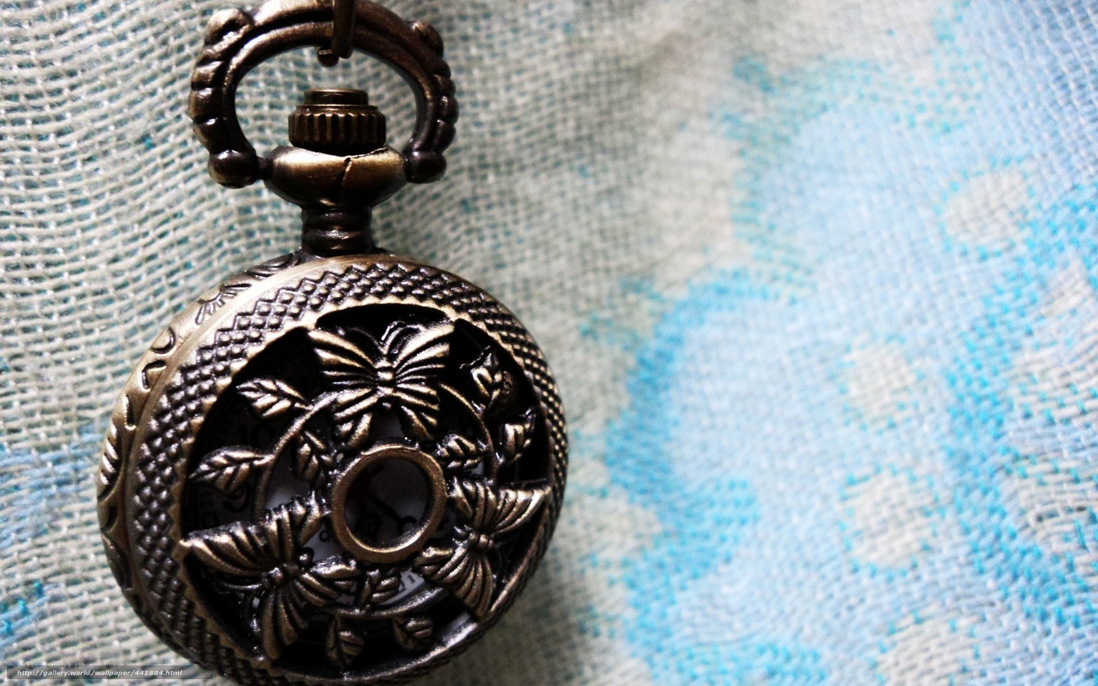 ornate pocket watch on fabric