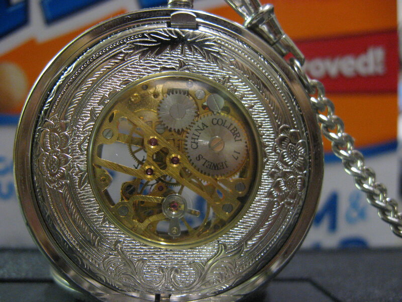 ornate pocket watch with visible gears