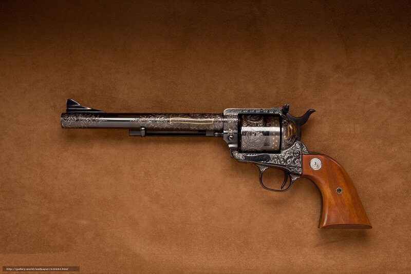 ornate revolver on brown surface