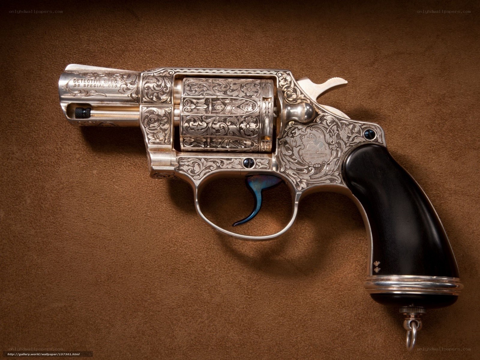 ornate revolver on brown surface