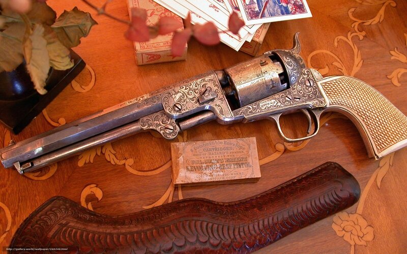 ornate revolver on wooden table
