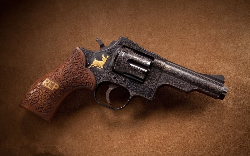 ornate revolver with gold details