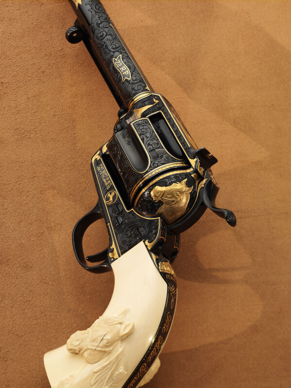 ornate revolver with horse carving