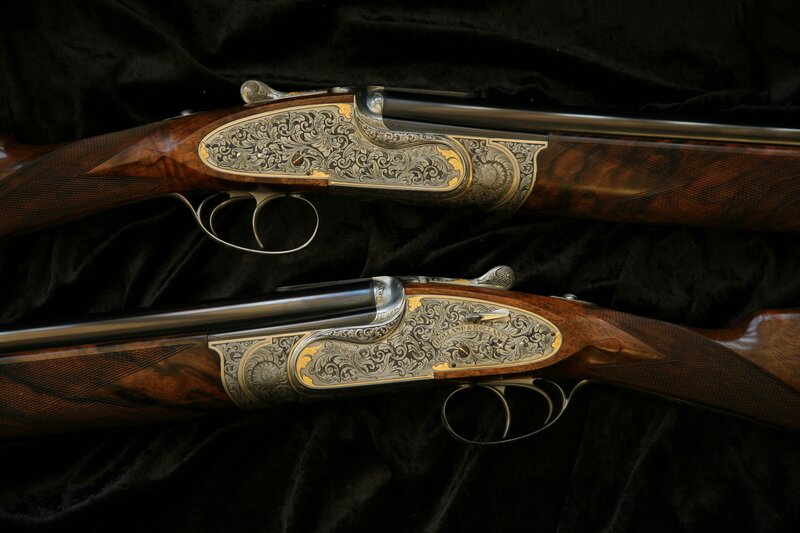 ornate shotguns on velvet