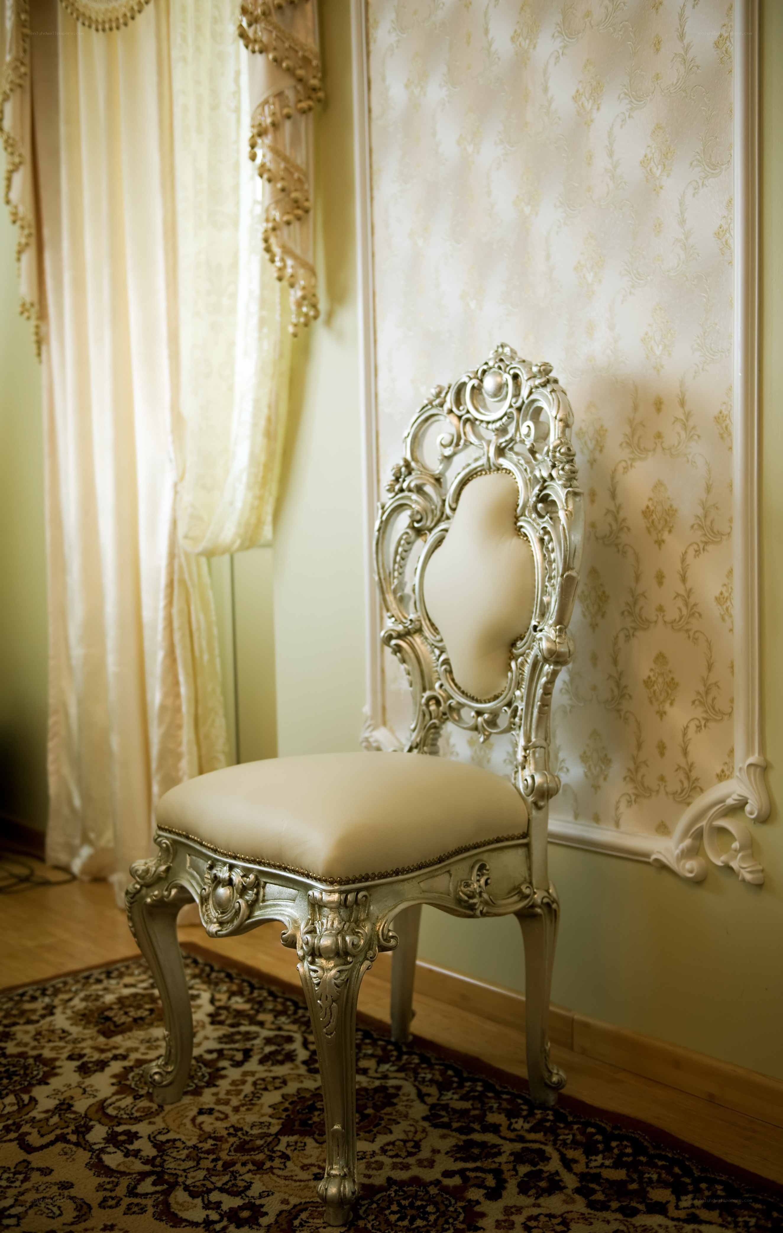 ornate silver chair in elegant room
