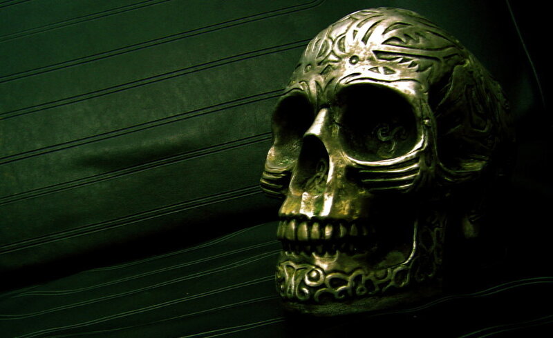 ornate skull on dark surface